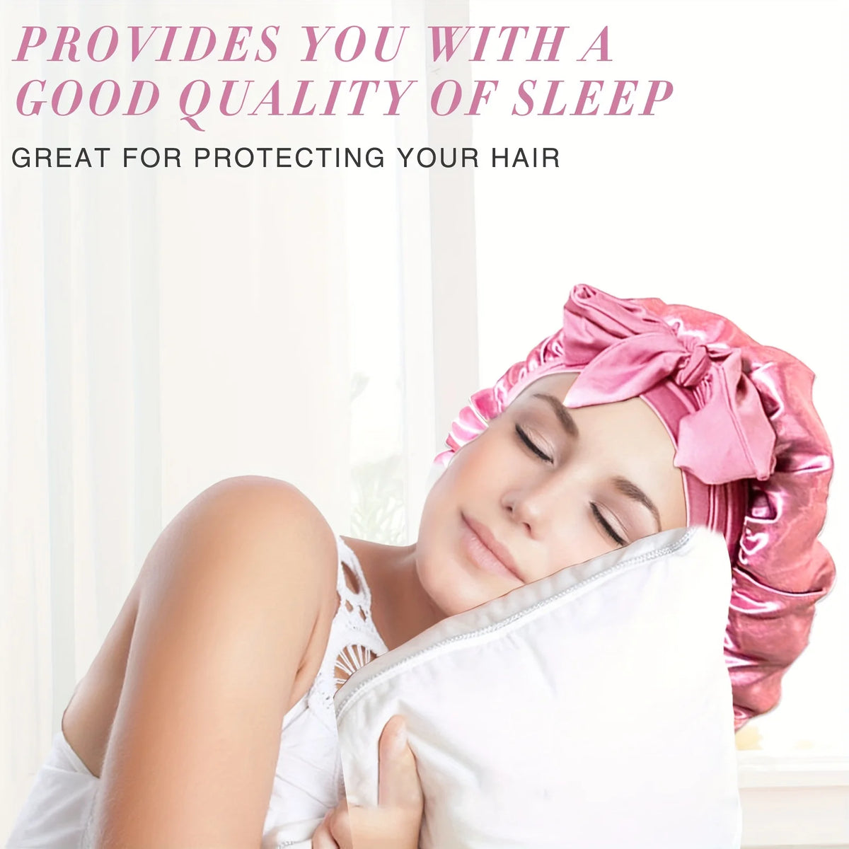 A woman is sleeping with a pink satin sleep bonnet on her head, resting on a white pillow.