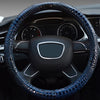 A close-up view of a black car steering wheel covered in blue crocodile grain leather.