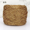 A ball of metallic gold silk crochet yarn with a shimmering texture for knitting and macrame.