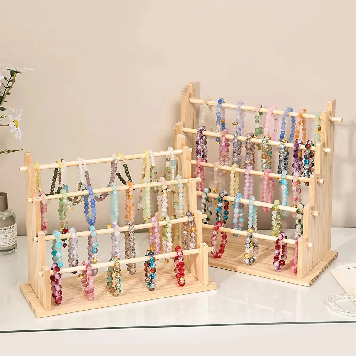 Solid wood ladder jewelry organizer displaying various colorful beaded necklaces and bracelets.
