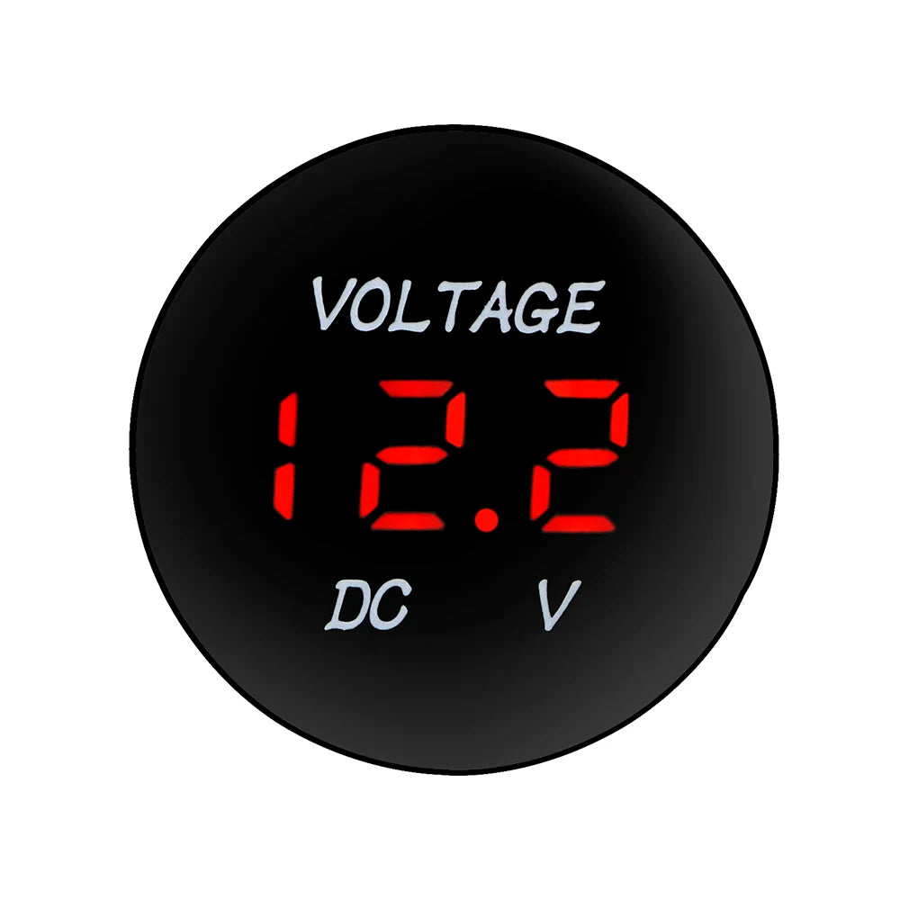 A round black digital voltmeter display showing 12.2 volts DC V.