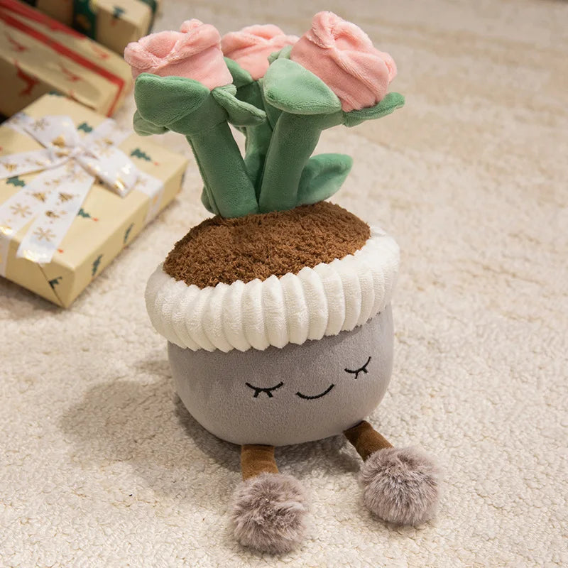 A cute artificial flower plush doll with pink roses and green leaves, sitting on a gray body with white trim.