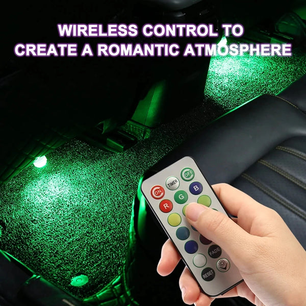A hand holds a remote control for wireless RGB car interior ambient lights, illuminating the green car dashboard.