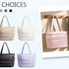 A variety of multi color quilted tote bags in pink, mint green, beige, and black shown with a neutral towel.