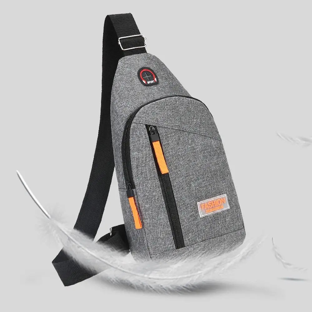 A gray Oxford canvas crossbody chest bag with black straps and an orange accent, shown against a light background.