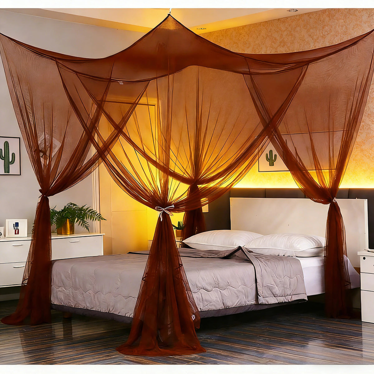 Elegant mosquito net bed canopy draped over a bed with sheer orange fabric.