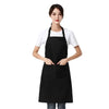 A woman wearing a black waterproof apron over a white shirt.