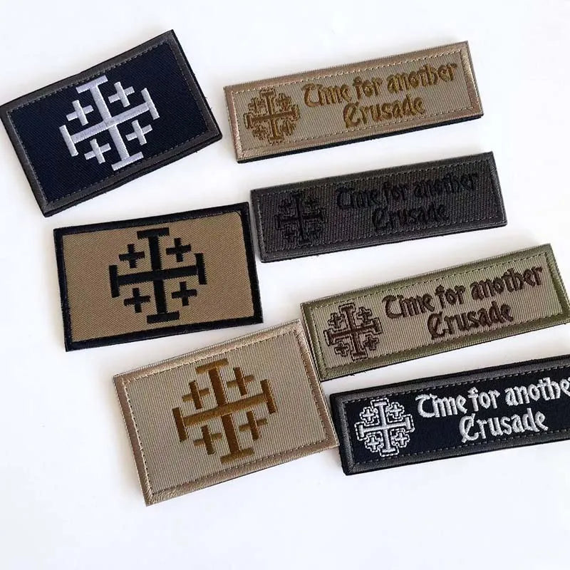 A collection of embroidered tactical patches featuring the Knights Templar cross design in various shades of gray and black.