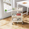 A white 3-tier rolling metal storage cart with lockable wheels holding various office supplies on a wooden floor.