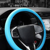 A blue silicone steering wheel cover installed on a car's steering wheel.