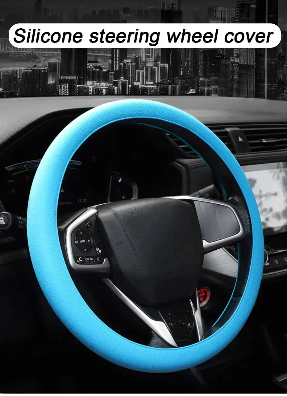A blue silicone steering wheel cover installed on a car's steering wheel.
