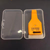 An orange automotive fuse tester tool is shown in its clear plastic case with a white insulating pad.