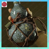 A handcrafted ceramic gourd wine set with a net bag is held in a hand against a dark background.