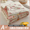 A lightweight summer quilt featuring a playful cartoon print in pink and white floral patterns.