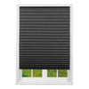 A dark gray pleated window blind installed in a white window frame.