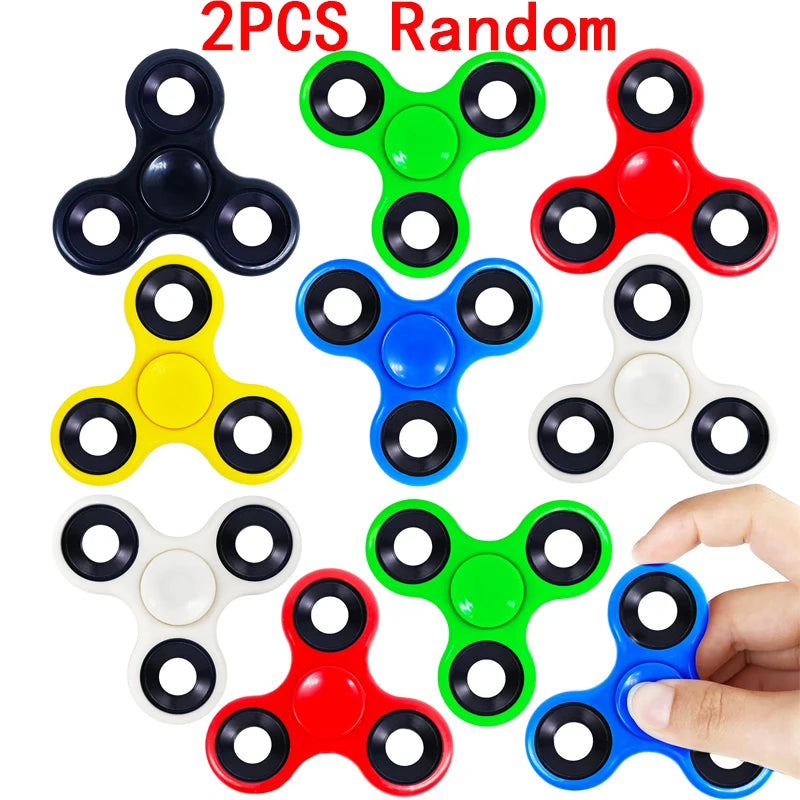 A collection of eight random color fidget spinners, including black, green, red, yellow, blue, white, and light blue.