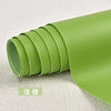 A roll of lime green self-adhesive PU leather patch for furniture and craft repairs.