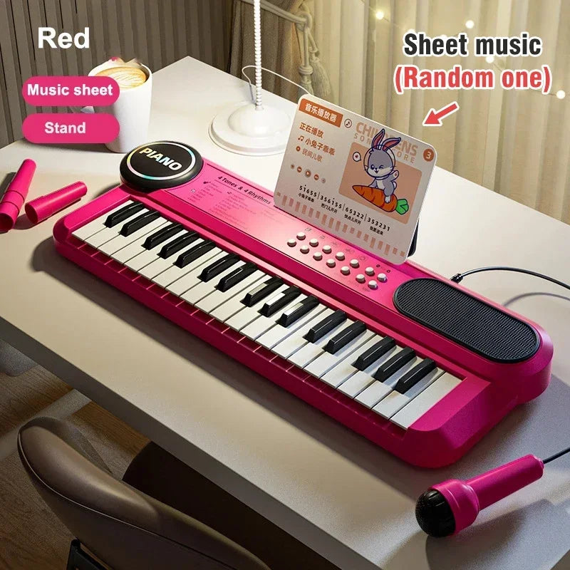 A pink electronic piano is displayed on a white table next to a microphone and music sheet.