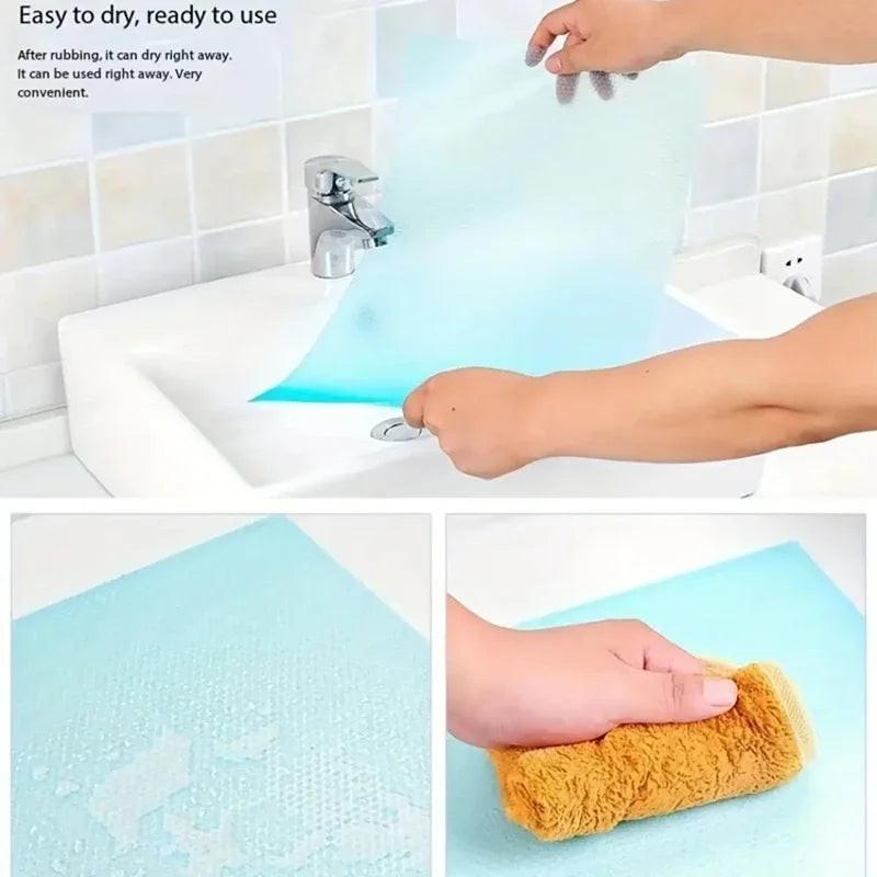 A hand is using a clear, flexible shelf liner to clean a kitchen sink or faucet.