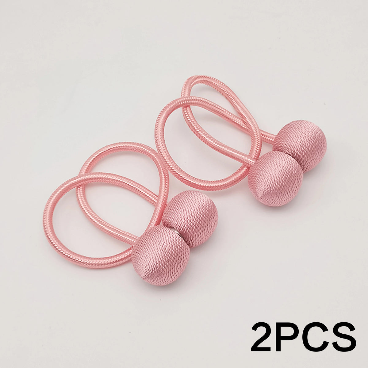 Deux attaches magnétiques minimalistes roses avec des boucles élastiques roses