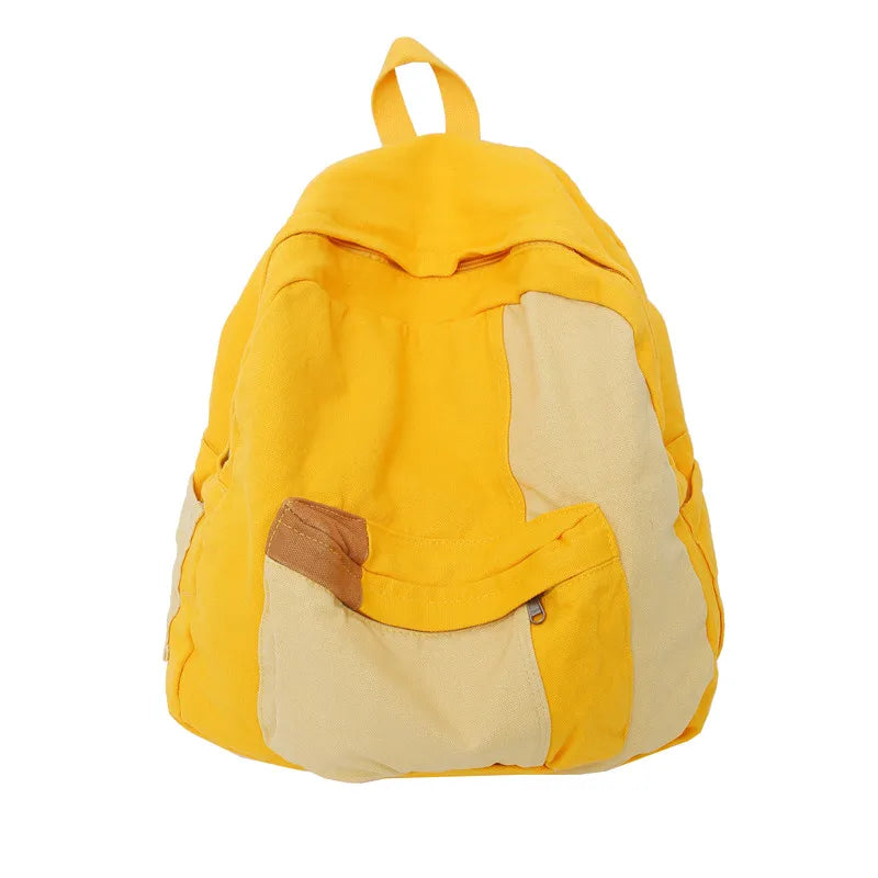 A yellow and beige canvas patchwork backpack with a yellow strap.