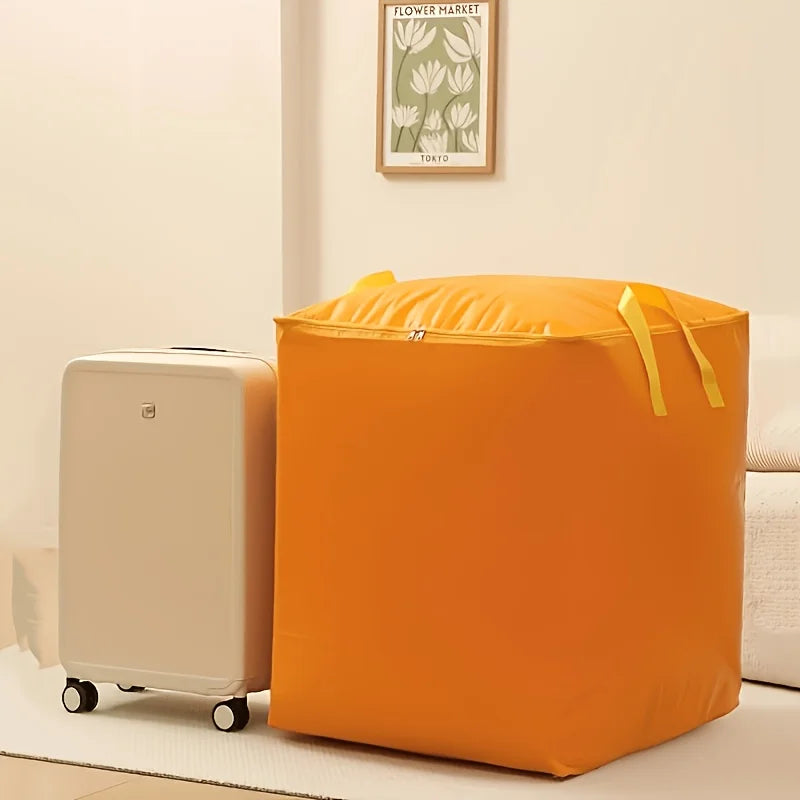 An orange heavy-duty waterproof moving bag standing next to a beige suitcase.