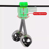 A close-up view of a fishing rod bite alarm bell with a clip-on indicator and a metal bell.