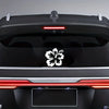 A black car rear view showing a white hibiscus flower decal sticker on the trunk and taillight area.