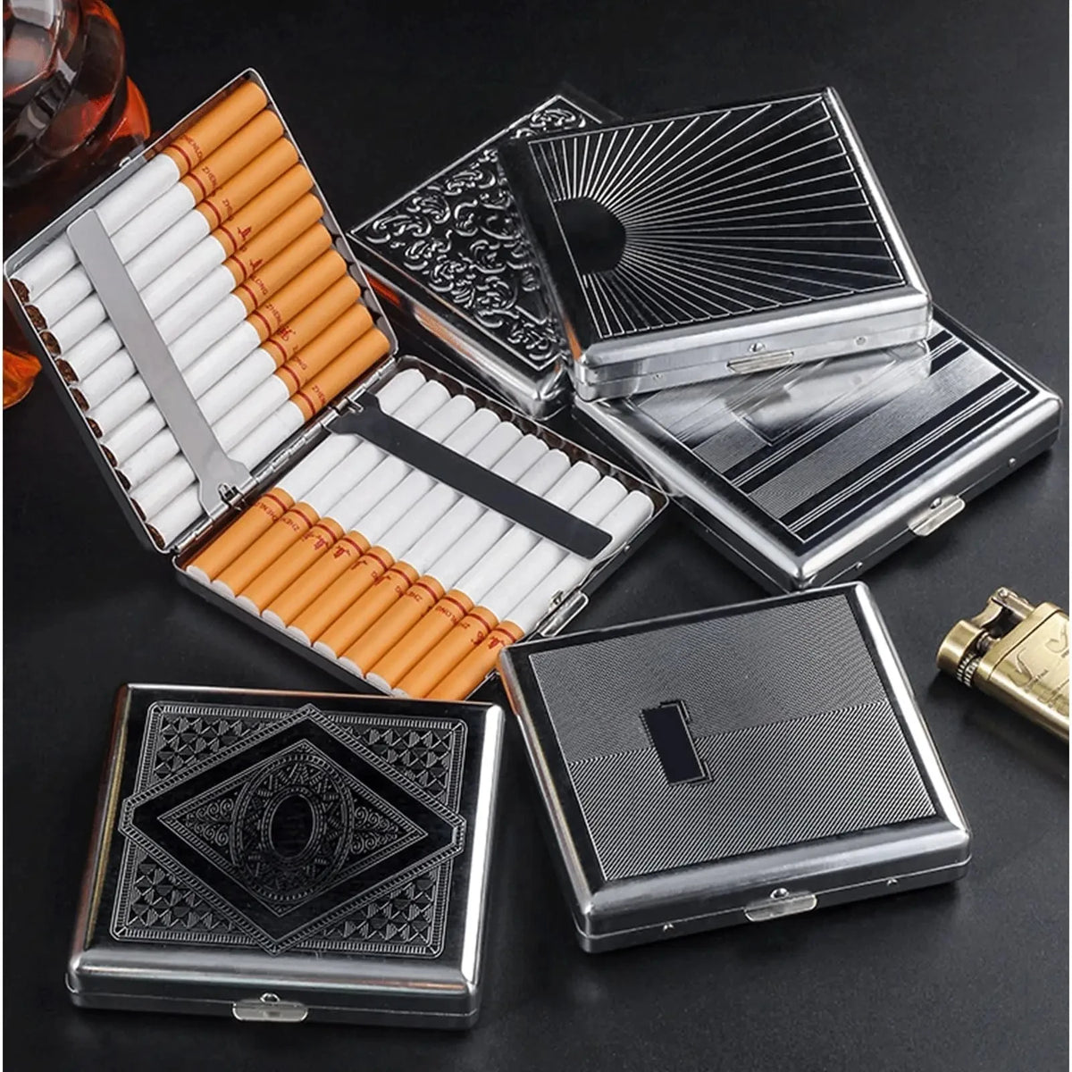 A collection of classic stainless steel cigarette cases with embossed patterns and orange accents.