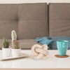 Handcrafted rustic wood knot decor in natural light wood resting on a white table.
