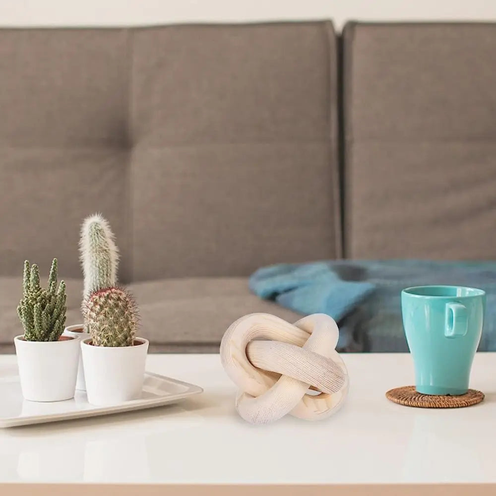 Handcrafted rustic wood knot decor in natural light wood resting on a white table.