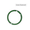 A circular crystal rhinestone start/stop button cover, set in a green diamond design.