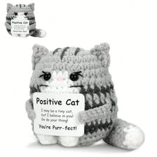 A gray knitted cat figurine with an inspirational card that reads Positive Cat You're Pure-fect