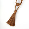 A set of two elegant brown tassel curtain tiebacks made of thick twine.