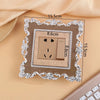 A rectangular switch cover frame with an elegant rose pattern border and a beige electrical outlet inside.