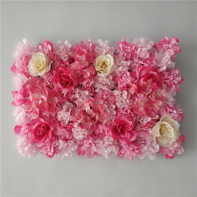 A dense wall panel of pink and white silk rose flowers for weddings and events.