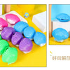 A collection of colorful mermaid shell squeeze toys in pink, purple, blue, and green are displayed on a yellow background.