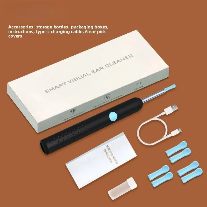 A white box and a black ear cleaner device with a light and cable are shown on a brown surface.