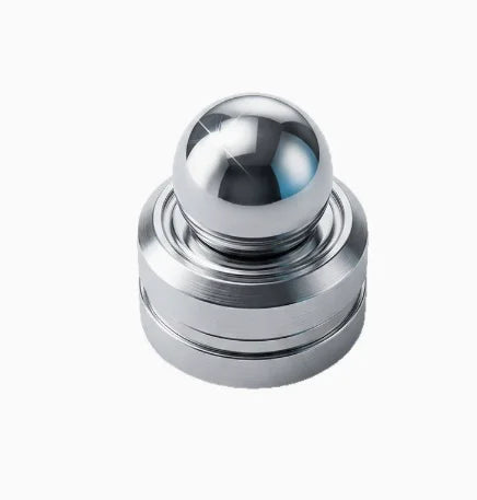 A polished silver metal desk spinner with a smooth, reflective ball top.