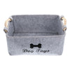 Gray felt pet toy storage basket with wooden handles and 'Dog Toys' text.