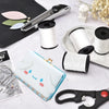A collection of heavy duty nylon thread spools, a leather tool, and upholstery needles are displayed on a white surface.