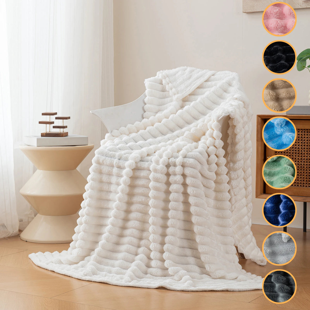 A white soft and cozy brushed flannel throw blanket draped over a light-colored chair in a bright room.