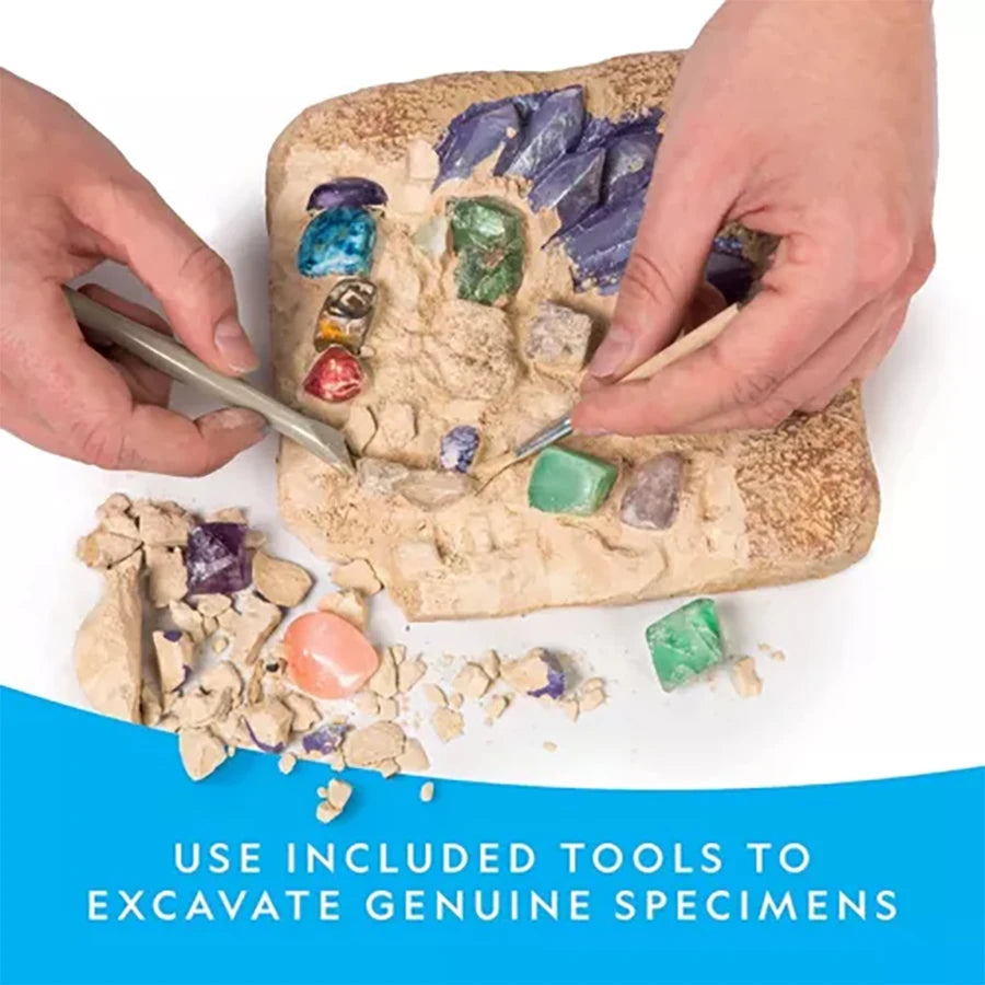 Hands excavating genuine gemstone crystals from a rock using included tools.