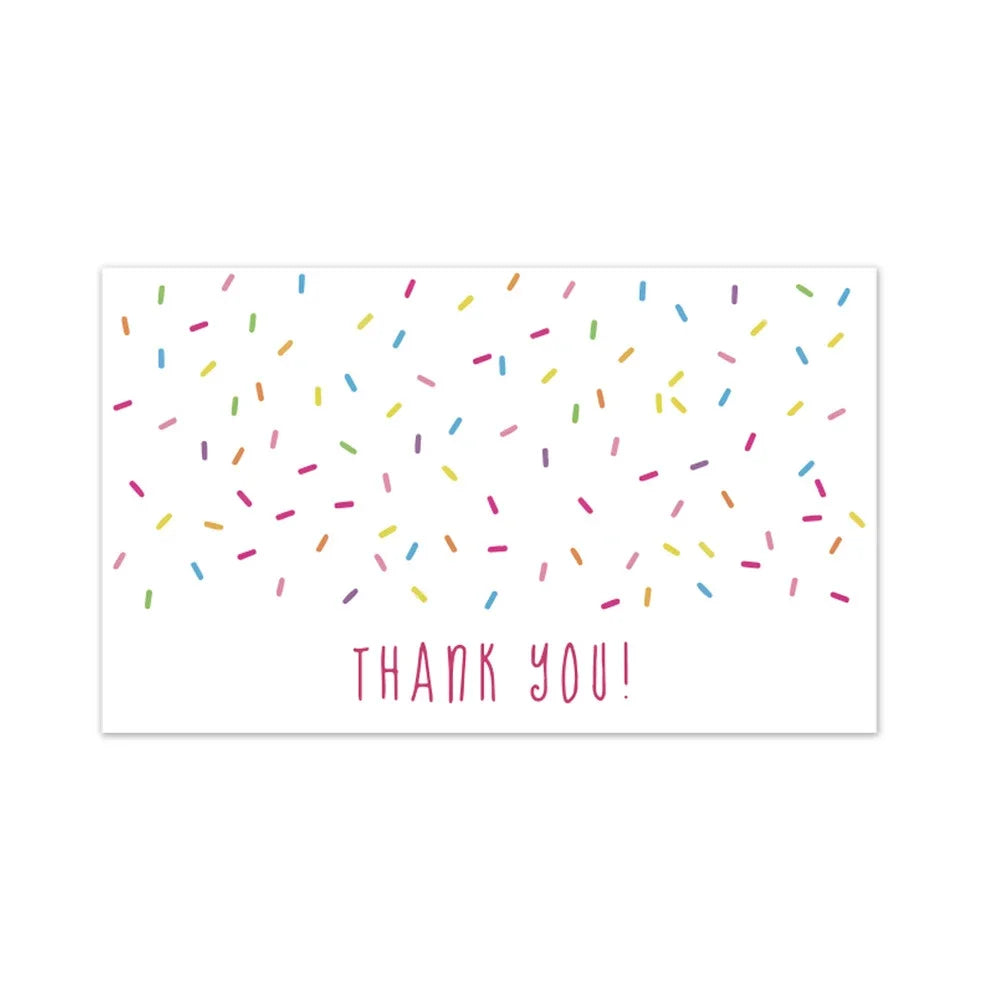 A white card with colorful confetti scattered across it and the text THANK YOU!