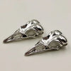 A pair of silver gothic skull and crow head charms for jewelry making