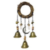 A rustic witch bells door hanger wind chime made of woven branches and brass bells.