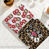 A clear tri-fold iPad case with a leopard print cover and a pink rose design is shown on a white surface.