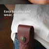 A brown leather folding knife case is shown being carried in a white shirt and denim jeans.