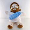A plush toy of Jesus with a beard and halo, wearing white clothing and a blue cloth.