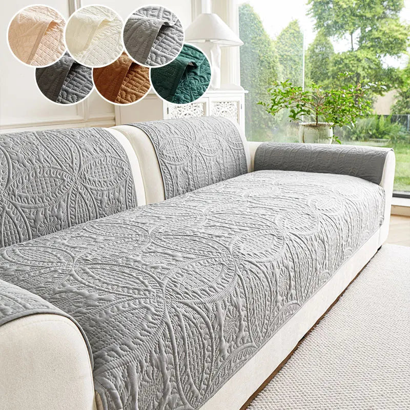 A gray anti-slip sofa cover is displayed on a light-colored sofa, with swatches of various fabric textures above it.